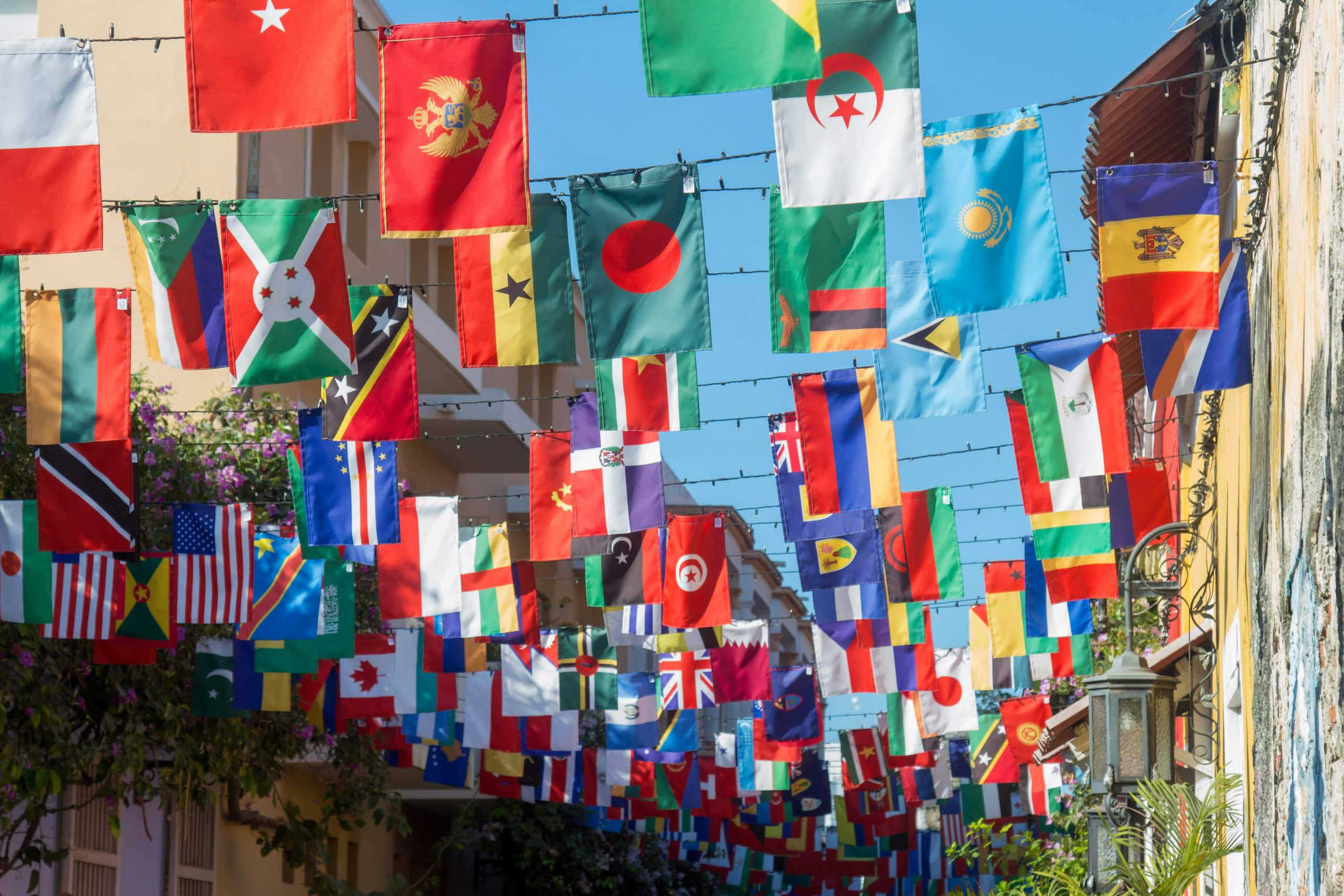 Flags of different countries hanging above a street