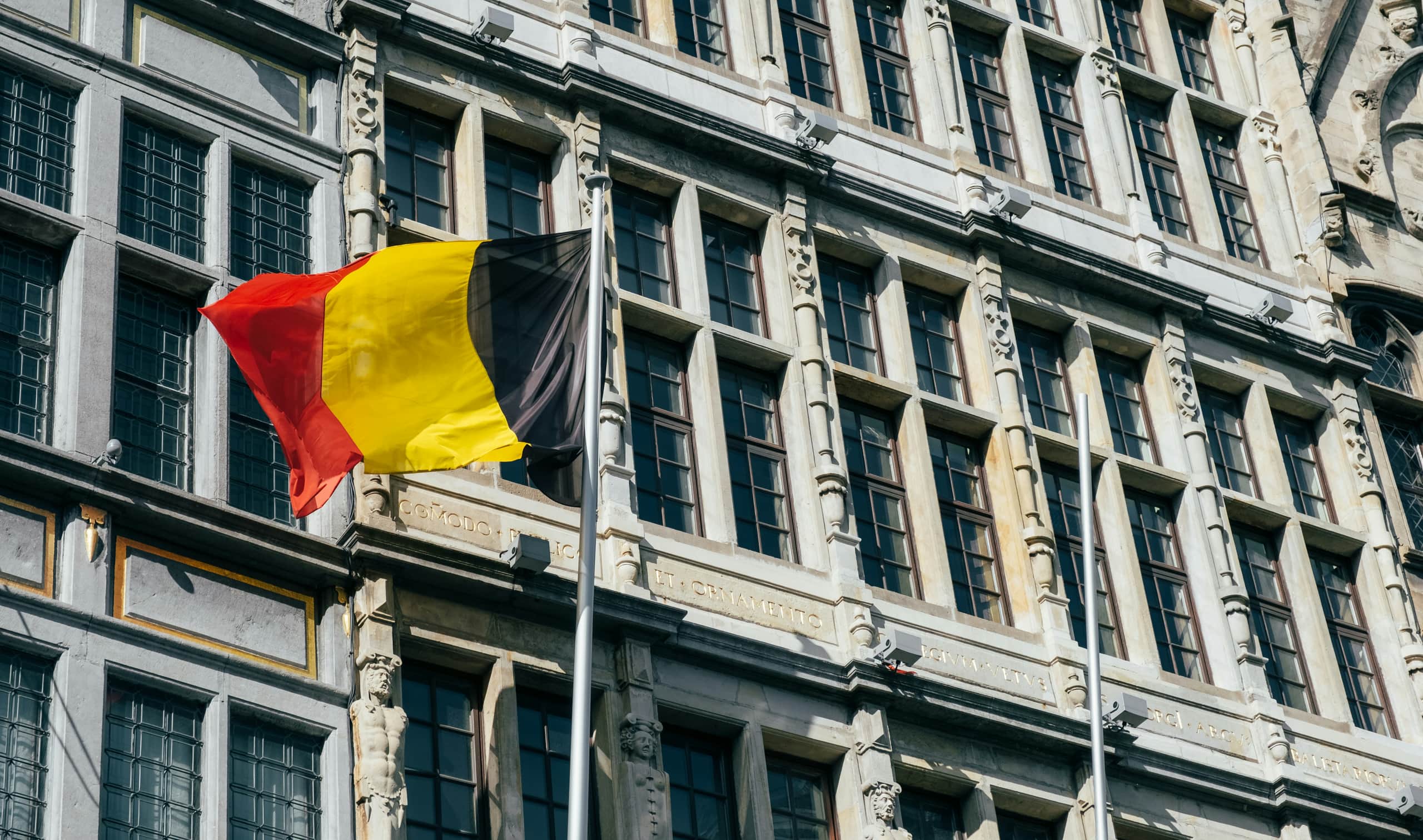 Belgian flag in front of a historic facade